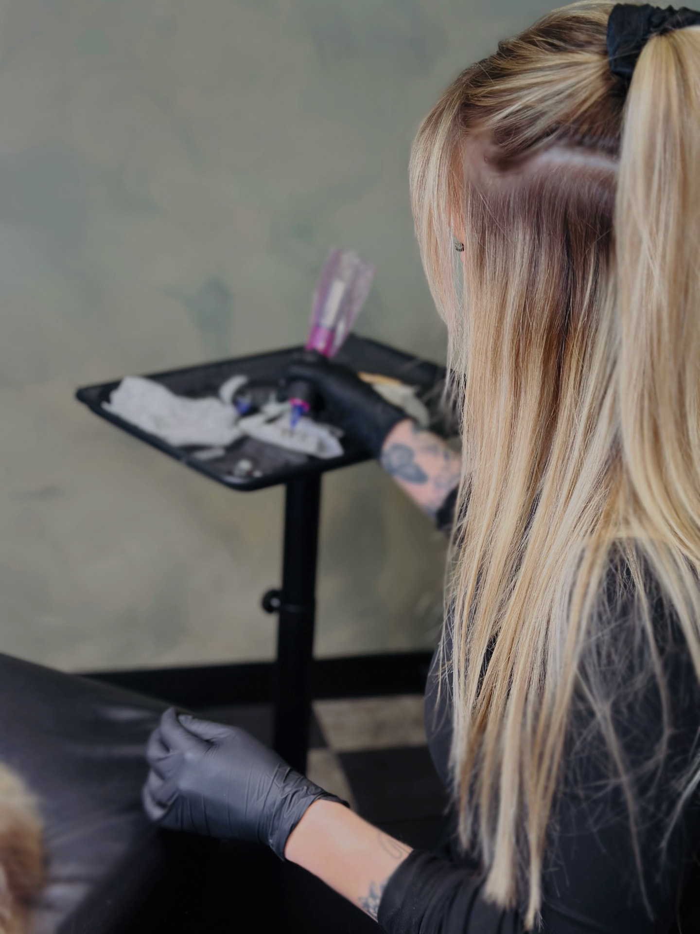 Kaylee working at her tattoo station